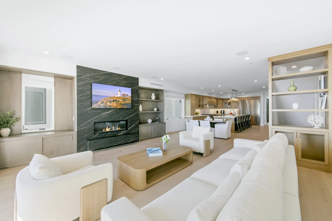 Living room with stone fireplace and built-in shelving